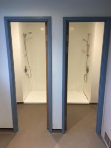 Altro Whiterock hygienic wall cladding installed in corporate shower cubicles